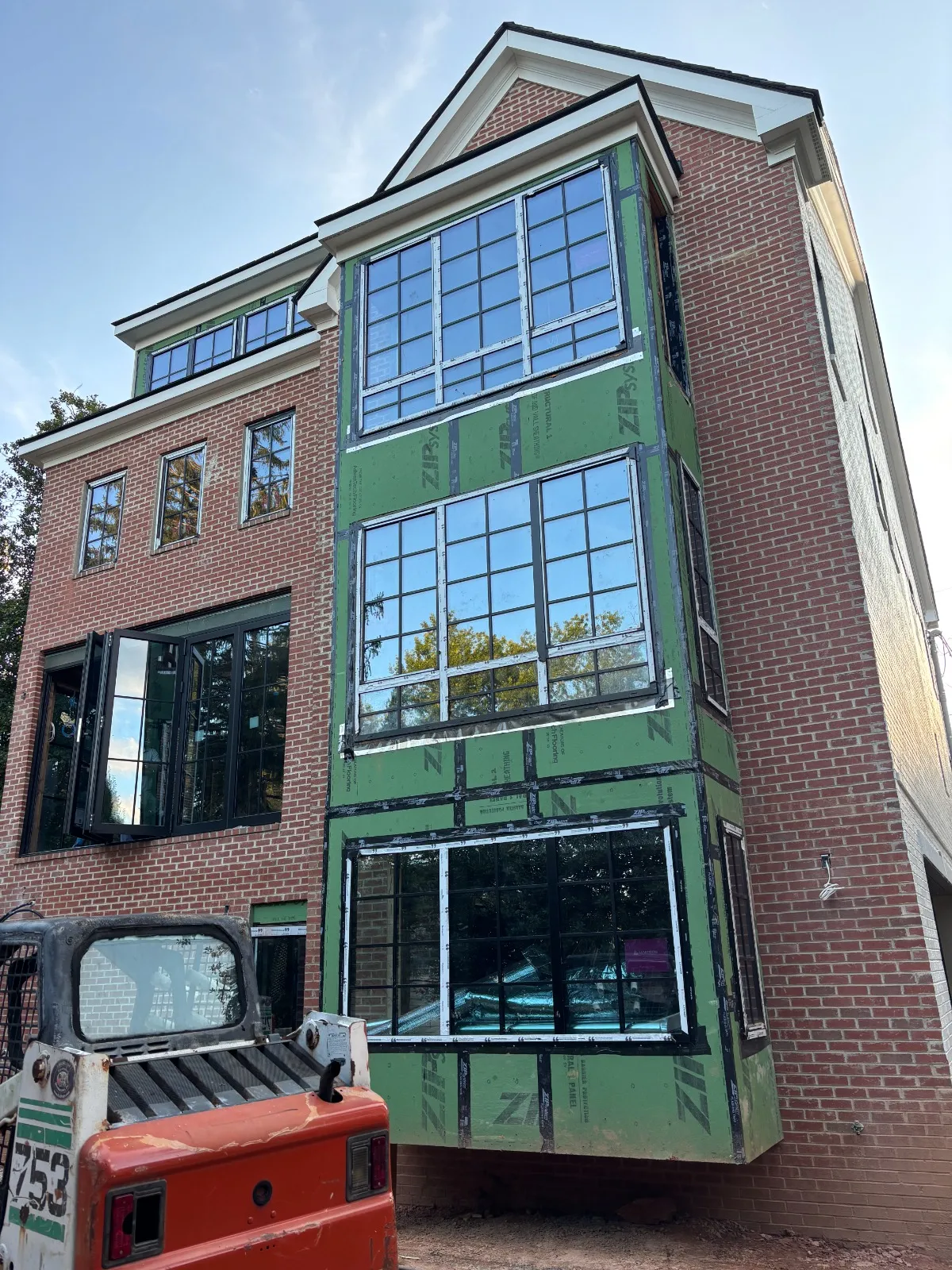 Custom home exterior with a large arrangement of black-framed windows
